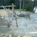 Designed and built a fieldstone retaining wall incorporating a dock fastener and a lakeside patio with a custom-made fire pit made of blue stone and natural fieldstone with a fire brick interior and a custom fabricated blue stone top. Project included excavation, drainage, final grading and masonry work. (Photo 1 of 2)